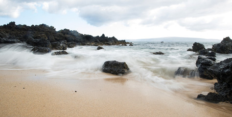 Powerful ocean current rushing in to beach