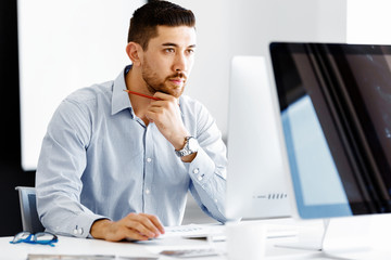 Naklejka premium Male office worker sitting at desk