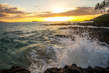 Ocean waves crashing on rocks at a tropical island beach