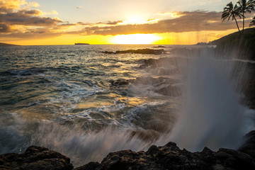 Ocean waves crashing on rocks at a tropical island beach