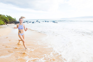 Fototapeta premium Teenage girl running on the beach