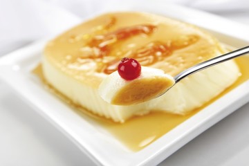 Creme caramel garnished with a redcurrant