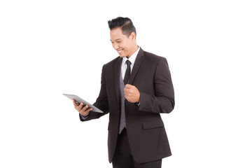 Businessman looking to tablet checking e-mail or shopping online on isolated background.