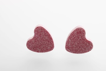 Two pink heart-shaped grape sugars