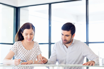 Image of two young business people in office