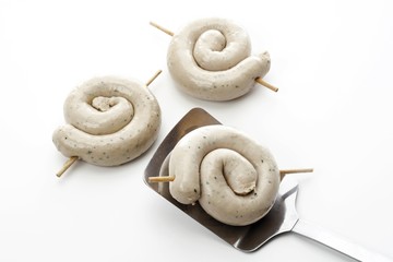 Rolled, raw bratwursts