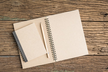 Top view notebook on rough wooden texture. Concept for education and business. Office top view background.