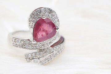 pink gemstone on diamond ring