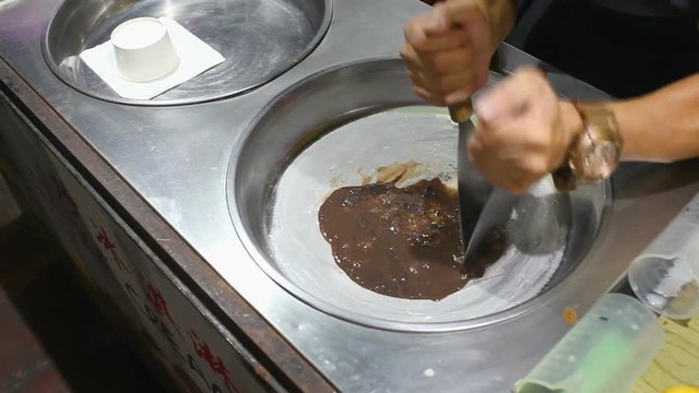 Men's Hands Cooking Ice Cream In The Street Cafe On Bukit Bintang Street In Kuala Lumpur