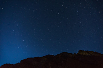 Naklejka premium Many starts on blue dark night sky as a cosmos background.