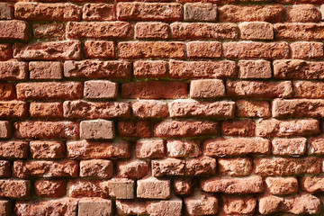Half destroyed red brick wall of shabby construction or house