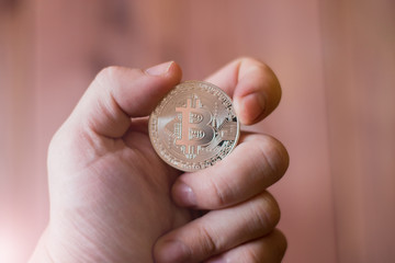 Bitcoins in the hand. A concept from coins of the cryptocurrency