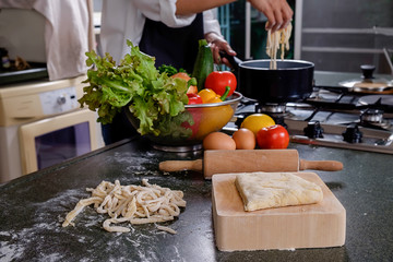 Young Woman Cooking in the kitchen. Healthy Food.