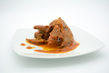 cooked birds in tomato sauce on white dish
