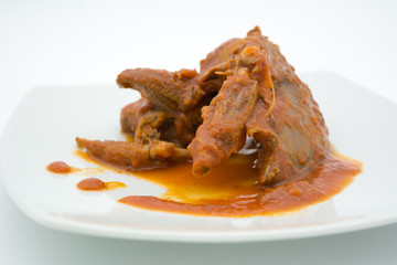 cooked birds in tomato sauce on white dish