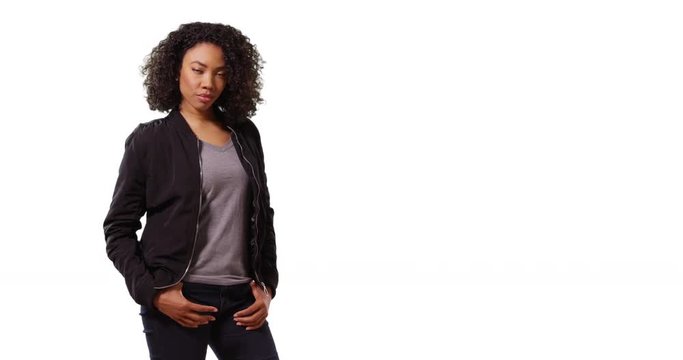 Portrait of cute black female looking at camera with cool confidence in studio