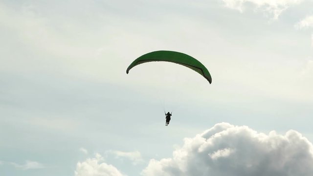 Paraglider in cloudly sky