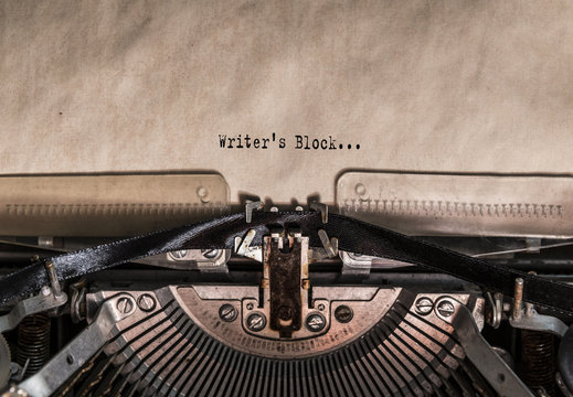 Writer's Block words typed on a Vintage Typewriter. Mechanisms closeup. Typing on old typewriter