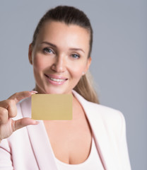 Business woman holding credit card against her face isolated