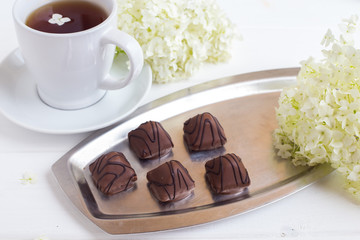 Chocolate sweets on a silver tray. Dessert for breakfast
