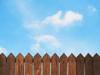 wooden fence against blue sky - Powered by Adobe