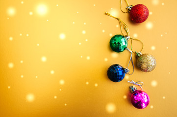 Colorful Christmas Balls on a golden background. Selective Focus. Copy Space. Top View.