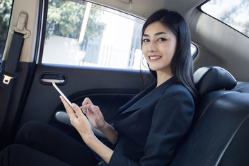 Woman using Smartphone for working in car, Woman working concept.