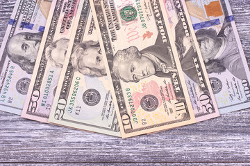 Money dollars on gray wooden background. Space.