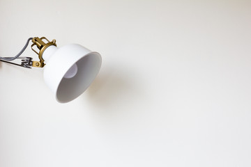 Adjustable white lamp on the wall background