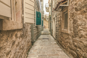 Old Town Street Budva, Montenegro. The first mention of this city - more than 26 centuries ago. We see ancient houses, a very narrow street, cafes, shops.