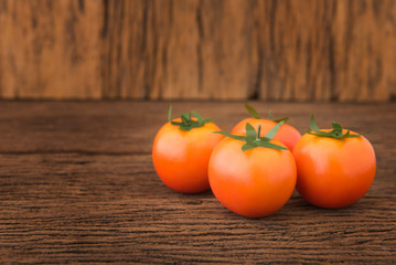 Close-up of fresh  tomatoes on wood background.