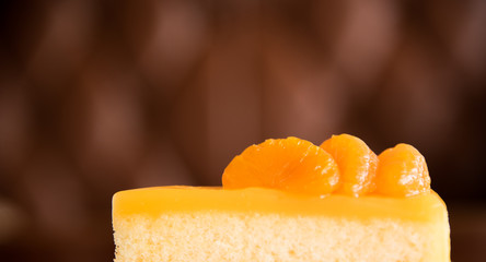 Orange cake with blur brown background