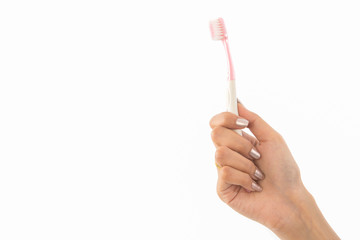Woman hand holding a toothbrush, isolated on a white background, This image for healthcare concept.