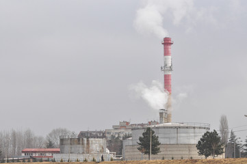 Dirty grey smoke from smokestack in the city. Smoke from district heating