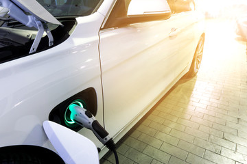Power supply connect to electric car for add charge to the battery. Charging re technology industry...