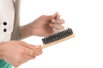 Portrait of asian woman long hair with a comb and problem hair on white background, Free form copy space.This image for hair loss concept.