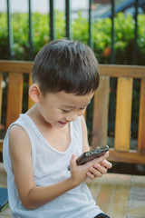 Portrait of asian boy use smartphone talk with mom, FaceTime, Miss mom concept.