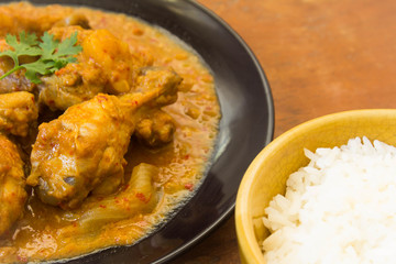 Massaman chicken and rice in the bowl. placed on a wooden table Old brown.,spicy muslim curry muslim food spicy. Eaten with rice or roti