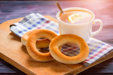 Tea with lemon and bread on a wooden table
