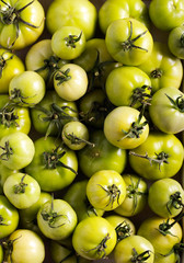 Raw green tomatoes in wooden box