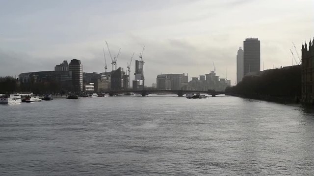 Construction of modern buildings in the distance in the Vauxhall area along the river Thames, London