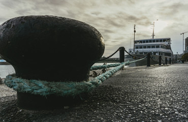 White tourist liner at the wharf tied with a rope