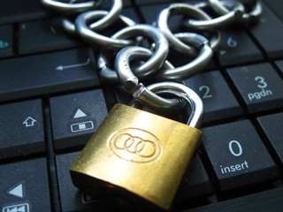Chain with lock on computer keyboard. It means laptop banned or internet banned. Symbol of computer addiction, games, social networks and so on