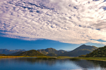 Naklejka na ściany i meble Incredibly beautiful clouds over the Skadar Lake. Montenegro.