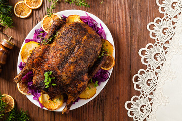 Baked whole duck, served with apples, red cabbage, oranges and roasted fritters.
