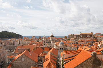 Fototapeta na wymiar Panorama of the old city of Dubrovnik. A view of the red roofs of the houses and the cathedral.