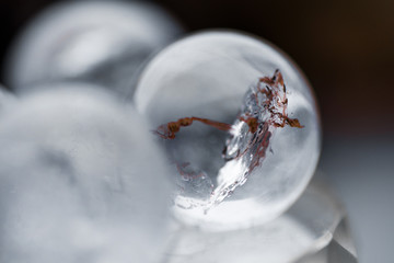 Fortune telling. Love, money, luck, success. Macro shot of transparent crystal ball with orange ornaments on glass pad with sun reflections in it