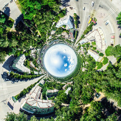 Aerial city view with crossroads and roads, houses, buildings, parks and parking lots, bridges. Helicopter drone shot. Wide Panoramic image.