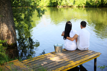 man and woman catch fish in the river