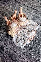 sea salt and himalayan in burlap. Crystals of salt on table